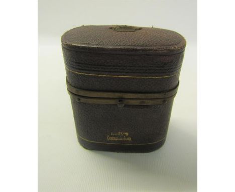 A 19c ladies companion containing seven tools and bottles enclosed within a brown leather gilt lined box with hinge cover, ha