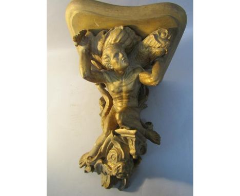 A 19c carved wood and stucco wall bracket, the stand supported by a male form riding upon a dolphin and supporting shells and