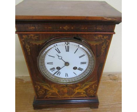 A late French mantel clock in rectangular rosewood case in inlays to front and sides depicting bowls of fruit, foliage and ur