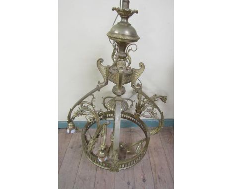 An early 20c gilded brass four light chandelier, leaf and scroll cast, 110cm h, 75cm diam max. 