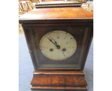 A mid 19c Black Forest mantel clock in rectangular case with flat cushion top and ogive base.  The 15cm diam metal dial sits 