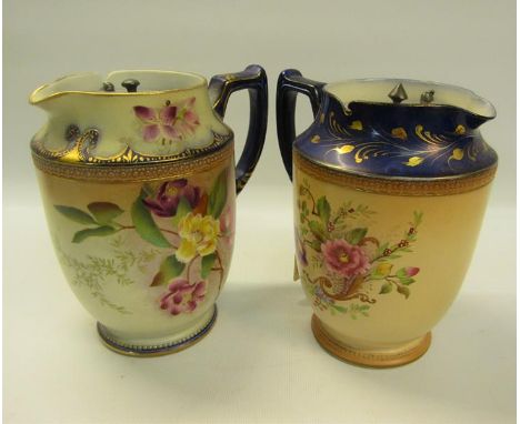 Two early 20c Carltonware water jugs with pewter lids, decorated on a blue and blush ground with floral decoration, 15.5cm h.