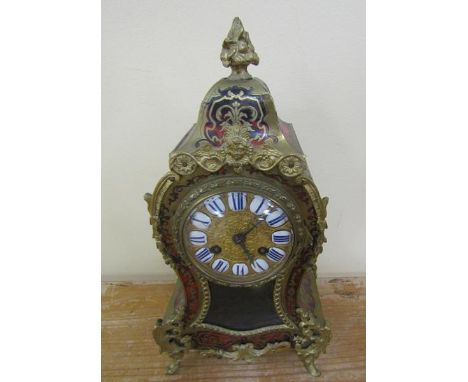 A late 19c French mantel clock in waisted boullework case of brass and tortoiseshell decorated with cast gilt mounts.  The em