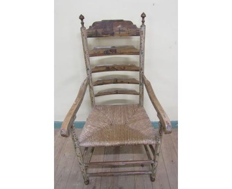 A 19c Dutch open armchair with ladder back and rush seat, the ladder backs rails painted with Dutch land and river scapes, th