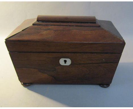 An early 19c rosewood tea caddy of sarcophagus form on compressed bun feet, 23cm w. 