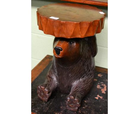 A black forest style carved wooden stool in the form of a seated bear 