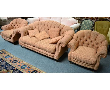 A buttoned hump back sofa with two matching armchairs (3)