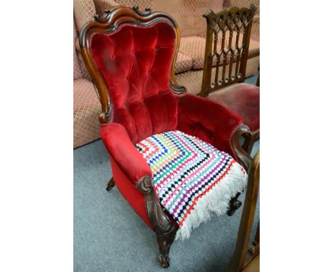 A Victorian carved mahogany framed button back armchair 