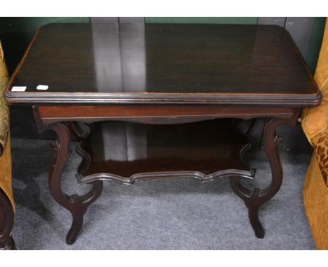 A mahogany fold over games table with shaped shelf structure 