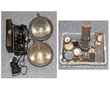 A group of miscellaneous items including a Thomas & Williams miners lamp, car clocks, metres, headlamps, a cased astro-compas