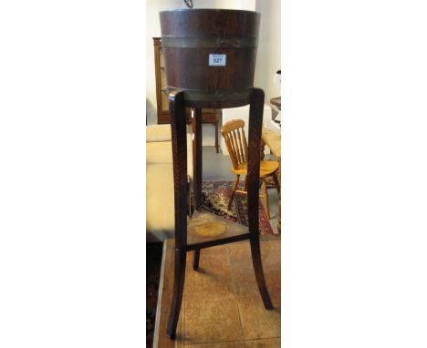 R. A. Lister & co. oak metal banded jardiniere on stand.(B.P. 24% incl. VAT)