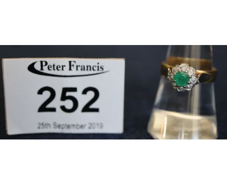 18ct gold emerald and diamond cluster ring. Approx. weight in total 4.5g