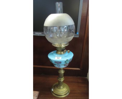 Brass double burner oil lamp with opaline glass reservoir having painted decoration on yellow metal base, frosted globular sh
