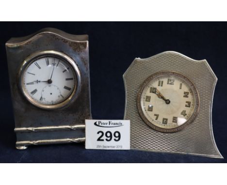 Silver watch holder case with silver key wind pocket watch together with a white metal engine turned art deco design alarm cl