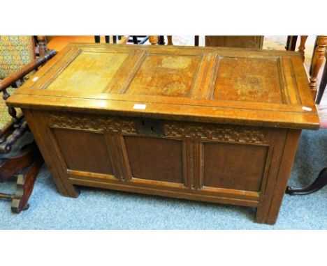 An 18th century oak three-panel coffer with carved frieze, 102cm wide