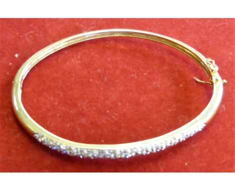 A 9ct gold and diamond hinged bangle set with brilliant cut diamonds, weight 10.5gms