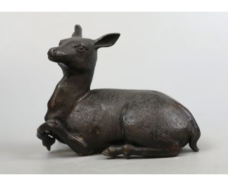 Antique bronze statue of a resting deer, or fawn, with no markings, but possibly Japanese.