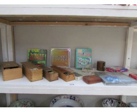 A shelf of vintage games including dominoes