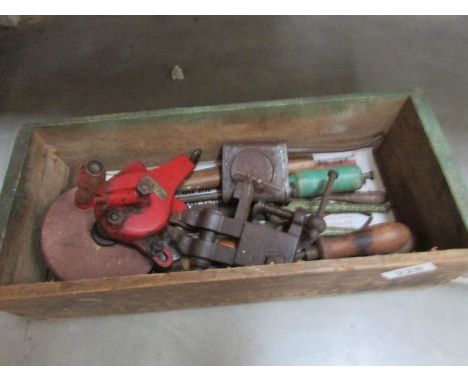 A box of tools including vice, hand grinder, oil tins etc