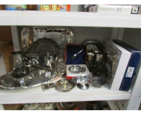 A shelf of assorted silver plate including trays, tankards, wedding gift set etc.