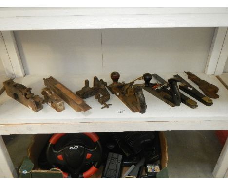 A shelf of tools including wood working planes