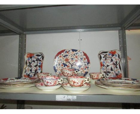 A shelf of oriental style table ware