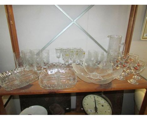 A shelf of assorted glass ware