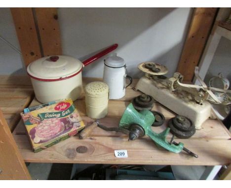 A shelf of vintage kitchenalia including scales, enamel ware etc.