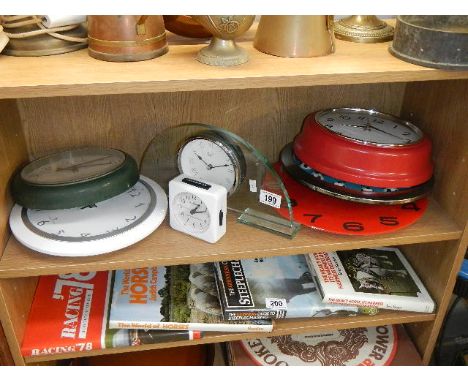 A shelf of assorted clocks