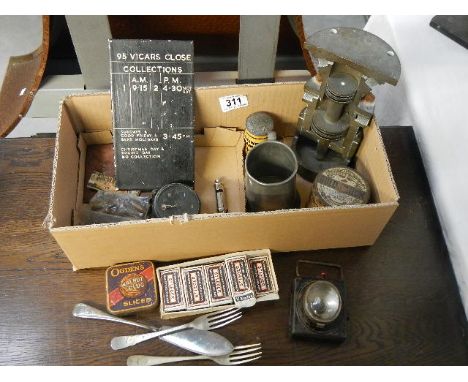 An interesting collection of tins, plaques, bike light, whistle etc