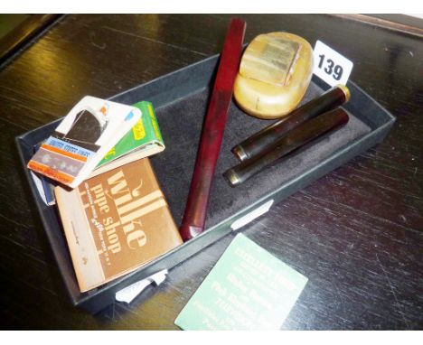 Amber bakelite cigarette holder, other cigar/cheroot holders, a horn snuff box (A/F), and some matchbooks