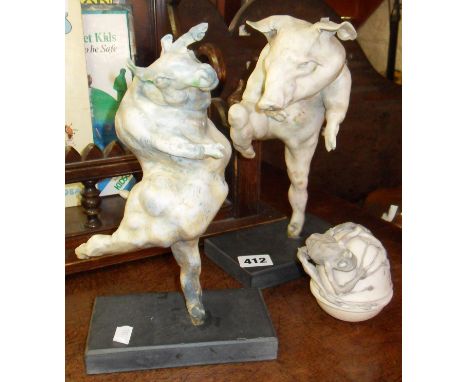 Studio Pottery - Ruth Barrett-Danes two stylised ceramic dancing pig figures on plinths, and a lidded pot with sprawling frog