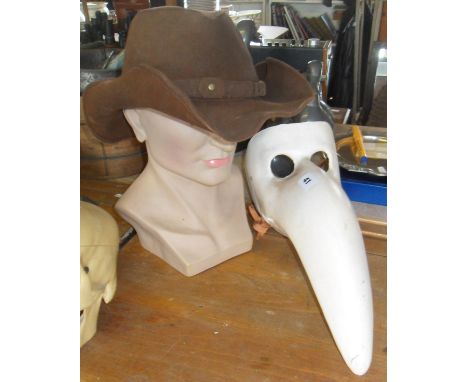 Comedia dell Arte beak mask, a leather stetson, and a man's head shop display mannequin