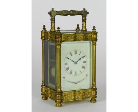A late 19th century gilt brass carriage clock, the 2 ¾ inch enamel dial with ring of Roman numerals over a floral swag, the c