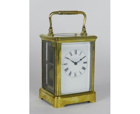 A late 19th century brass carriage clock, the 2½ inch enamel dial with ring of Roman numerals, the eight day spring driven mo