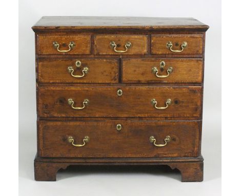 A mid 18th century oak crossbanded chest of three short over two short and two long drawers fitted with later brass swan neck