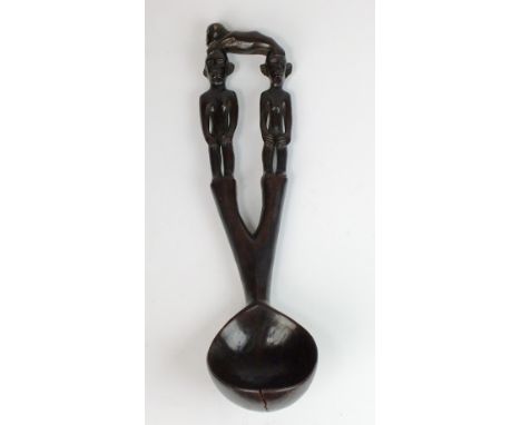 A large Philippines Ifuago carved wooden marriage spoon or ladle (bowl cracked, some chips to ears), 37cm high