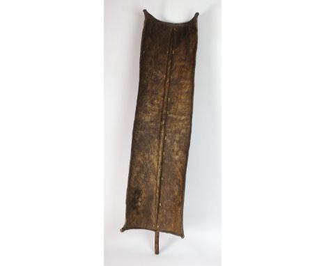 An East African Turkana tribe hide shield, early 20th century, 101cm high (inc central stick)