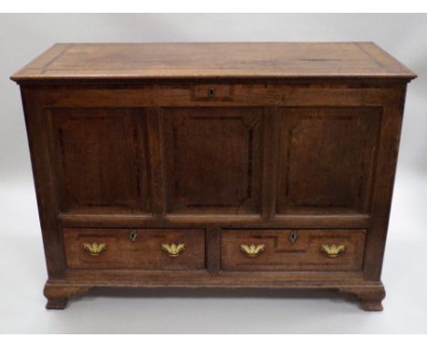 A George III oak crossbanded mahogany Lancashire type mule chest, the hinged lid over a three panel front with two drawers be