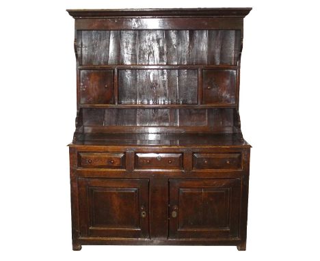 A mid 18th century oak high dresser, North Wales probably Denbighshire, the ogee moulded cornice over a long shelf with centr