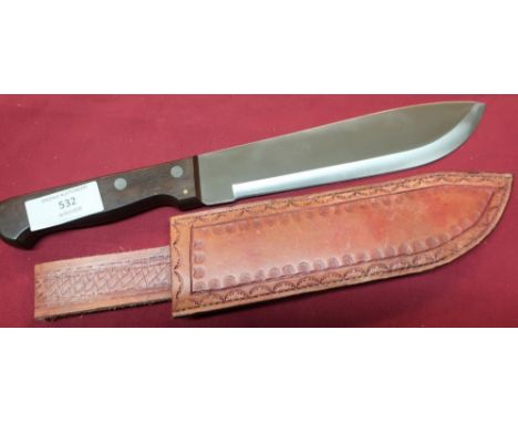 Short Dolo machete with 9 inch swollen blade, two piece wooden grips and tooled leather sheath, with lighting flint 