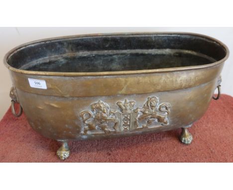 Brass oval planter with Belgium coat of arms crest to the front, ball and claw feet and lion mask handles (52cm x 21cm x 28cm