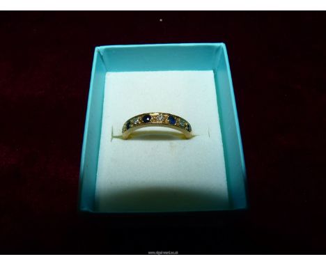 An 18ct gold Diamond and Sapphire half Eternity ring, size M.