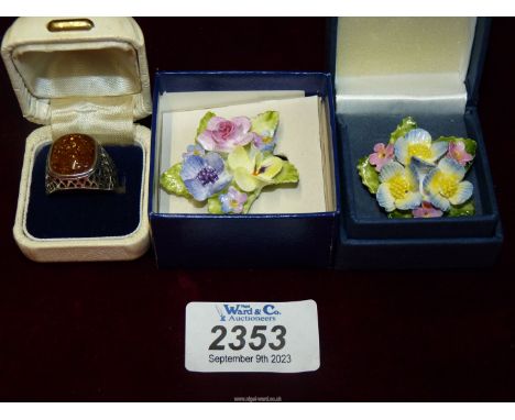 A Sterling 925 silver ring with amber stone and two English bone china brooches.