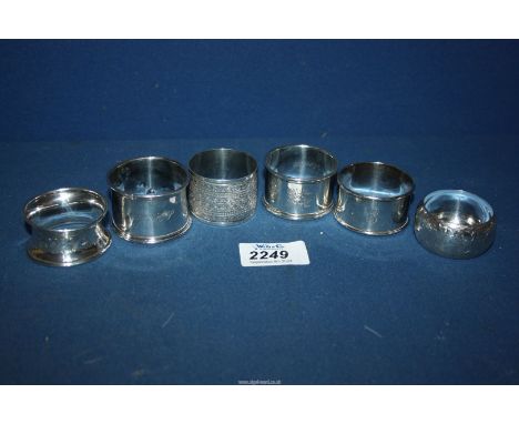 Five assorted Silver napkin rings, some engraved with monograms and flowers, Birmingham hallmarks plus a Chester 1923 napkin 