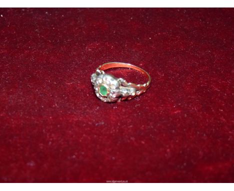 A pretty Georgian diamond and emerald ring - the small lozenge shaped emerald surrounded with rose cut diamonds, size P.