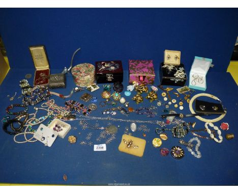A quantity of costume jewellery including necklaces, clip-on earrings, jewellery boxes, ring holder etc.
