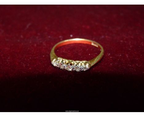 An 18ct gold Diamond ring, set with five small diamonds, size M (2g).