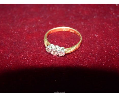 An 18ct plated engagement ring with three diamond chips.