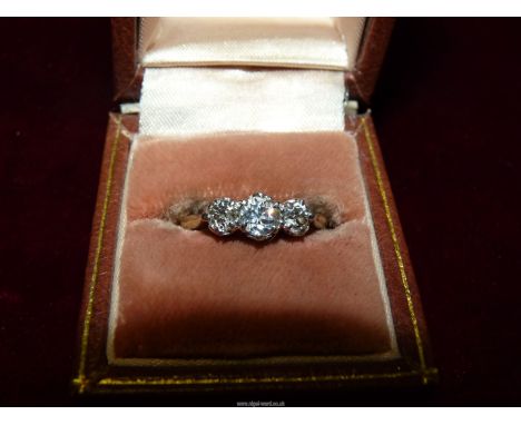An 18ct gold, three stone Diamond ring, size Q (3g).